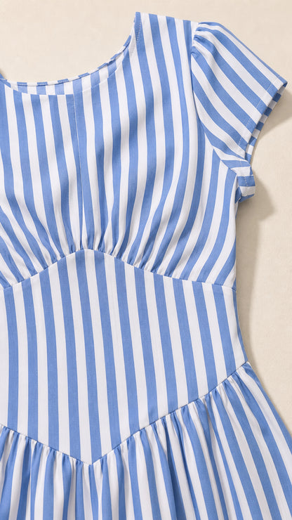 Close-up detail of blue striped fabric and bodice
