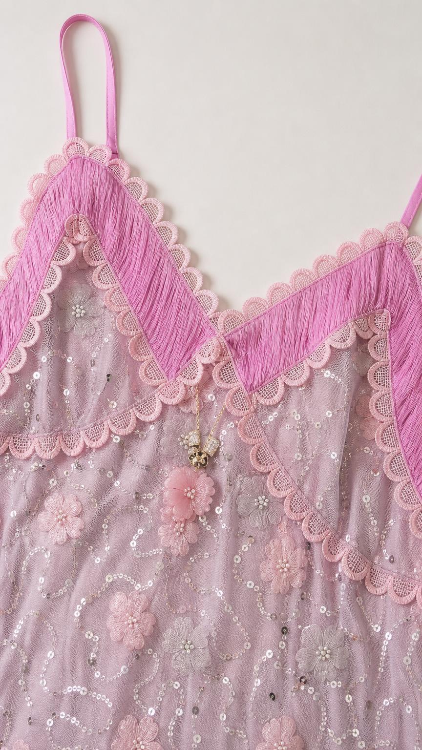 Close-up detail of bodice embroidery, sequins, and contrast trim on Lavender dress