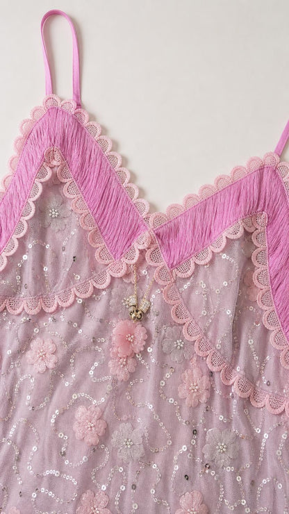 Close-up detail of bodice embroidery, sequins, and contrast trim on Lavender dress