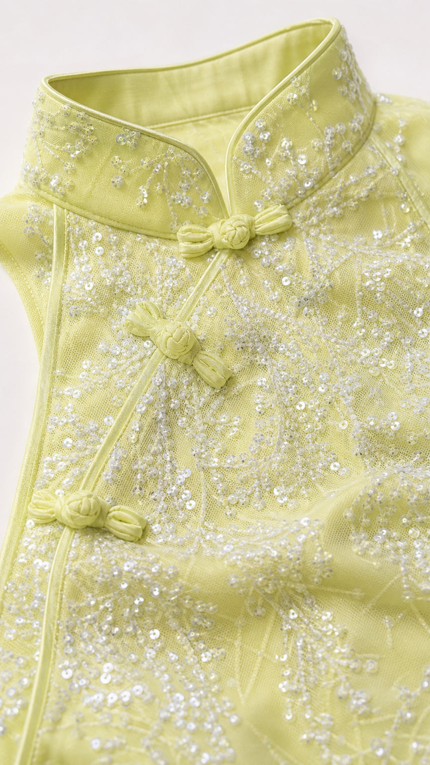 Close-up of mandarin collar and beadwork detail on lemon dress