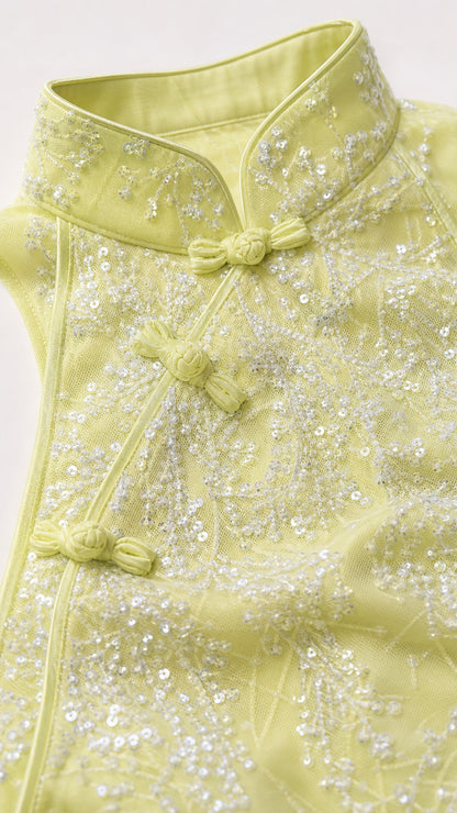 Close-up of mandarin collar and beadwork detail on lemon dress