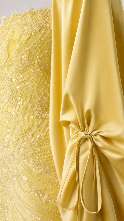 Close-up of fabric texture showing sequin embroidery and cape sleeve tie