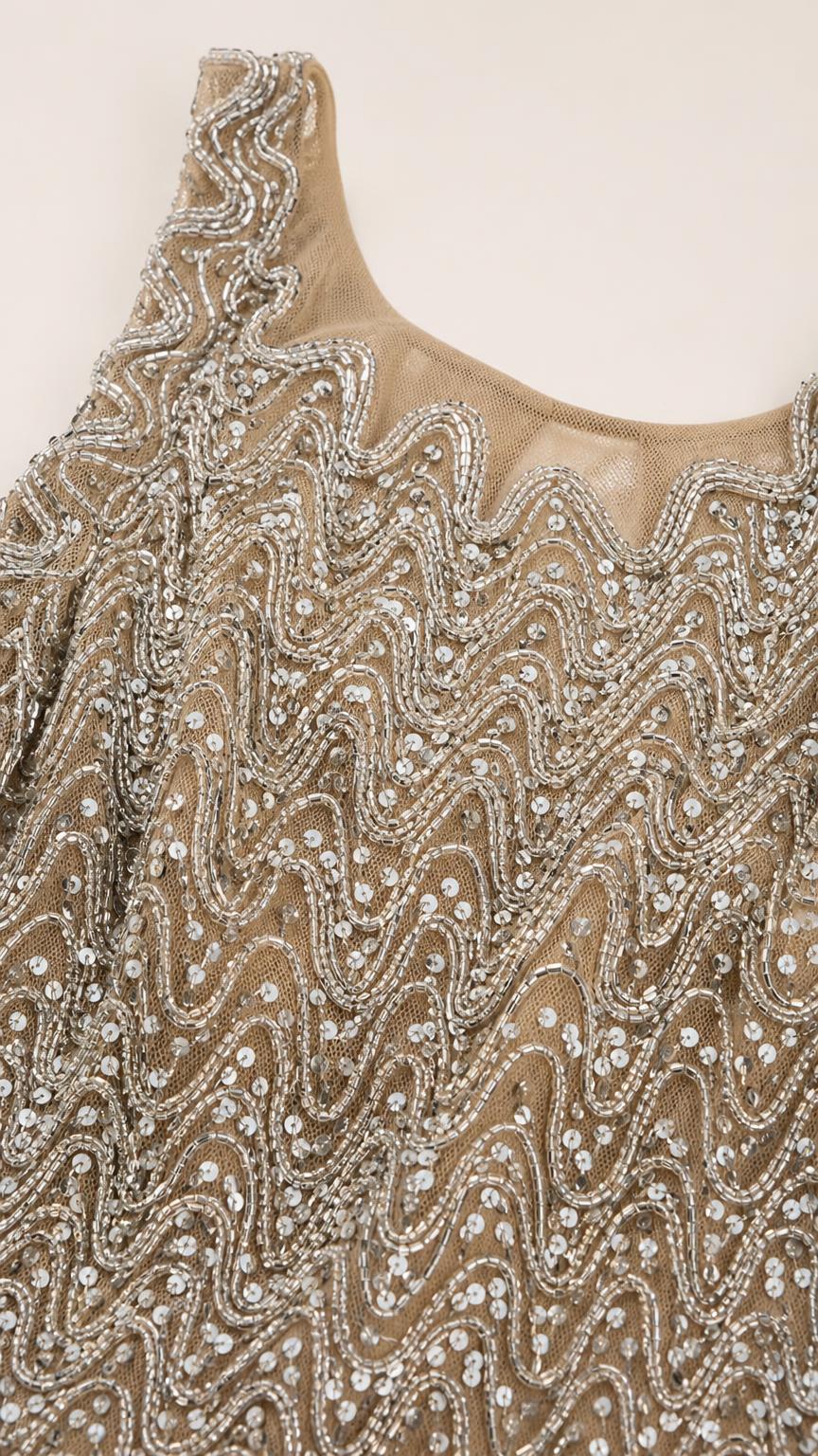 Close-up of champagne wave-pattern sequin and bead embellishments
