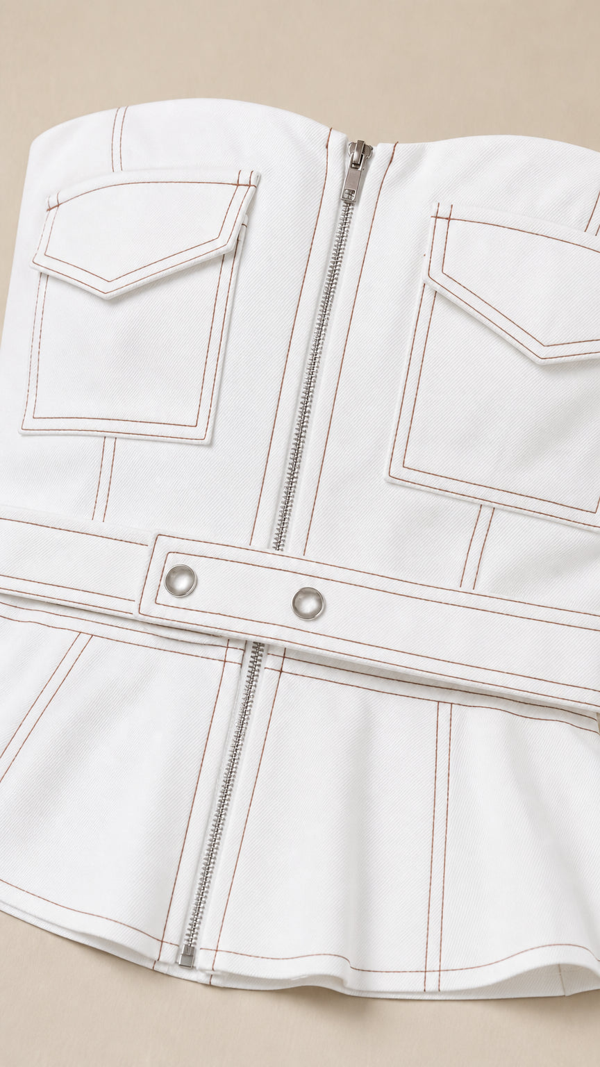 Close-up detail of white top with zipper and contrast stitching