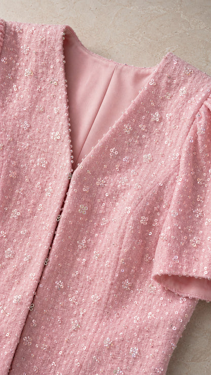 Close-up of pink textured sparkle fabric and V-neckline