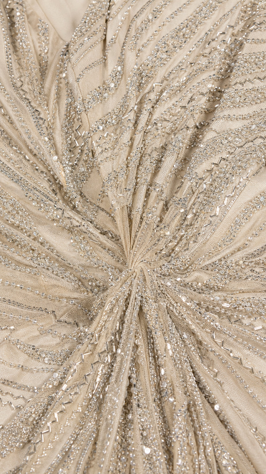 Close-up detailed texture of radiating beadwork and sequins gathered at the waist