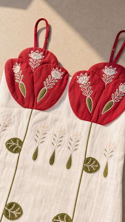 Close-up detail of red embroidered bust cups and stem pattern