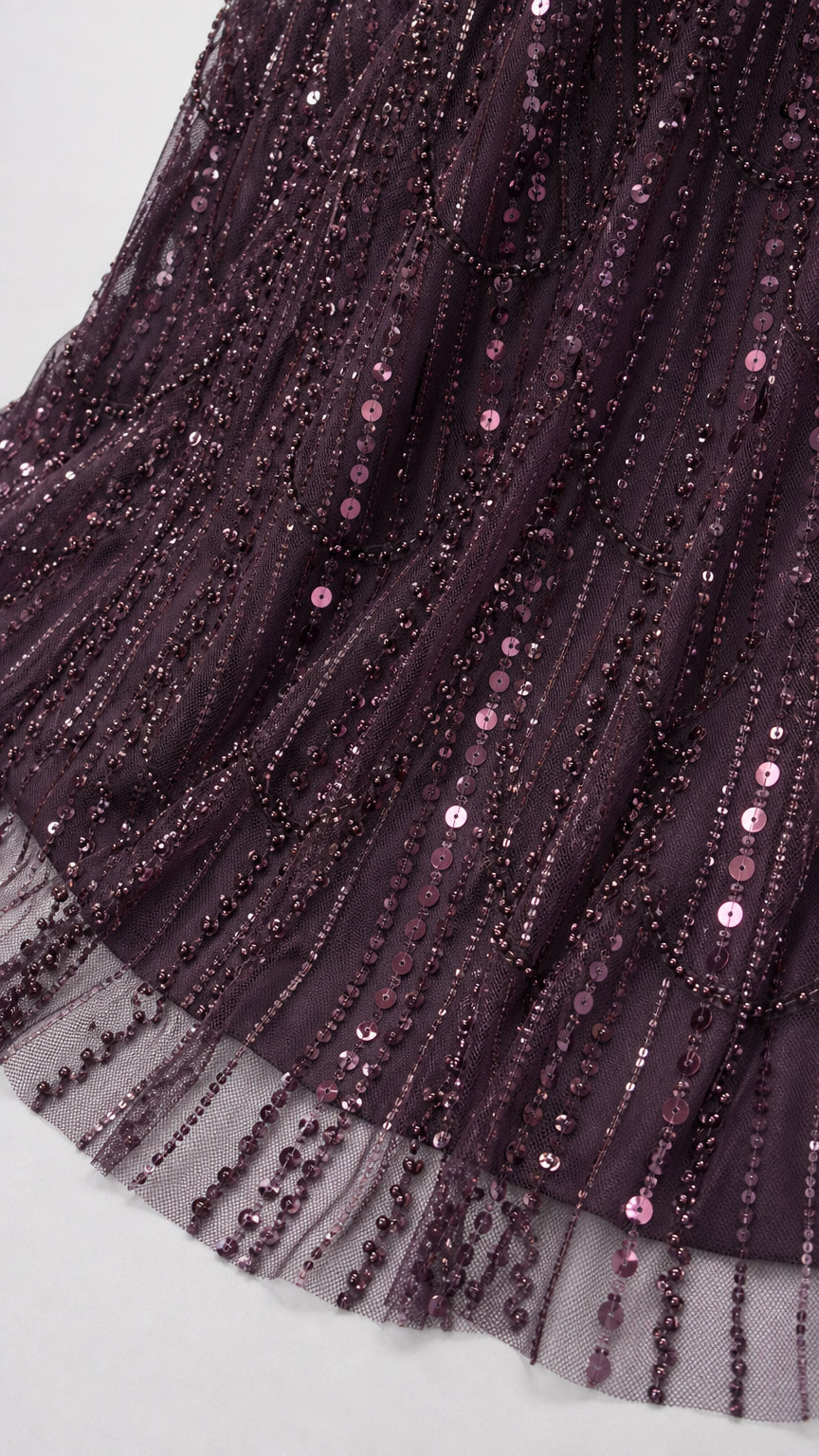 Close-up detail of sheer mesh hem with vertical plum sequin and bead embellishments