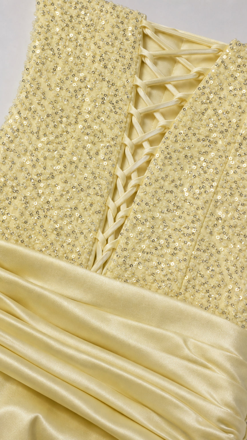 Close-up of yellow sequin bodice and lace-up back construction