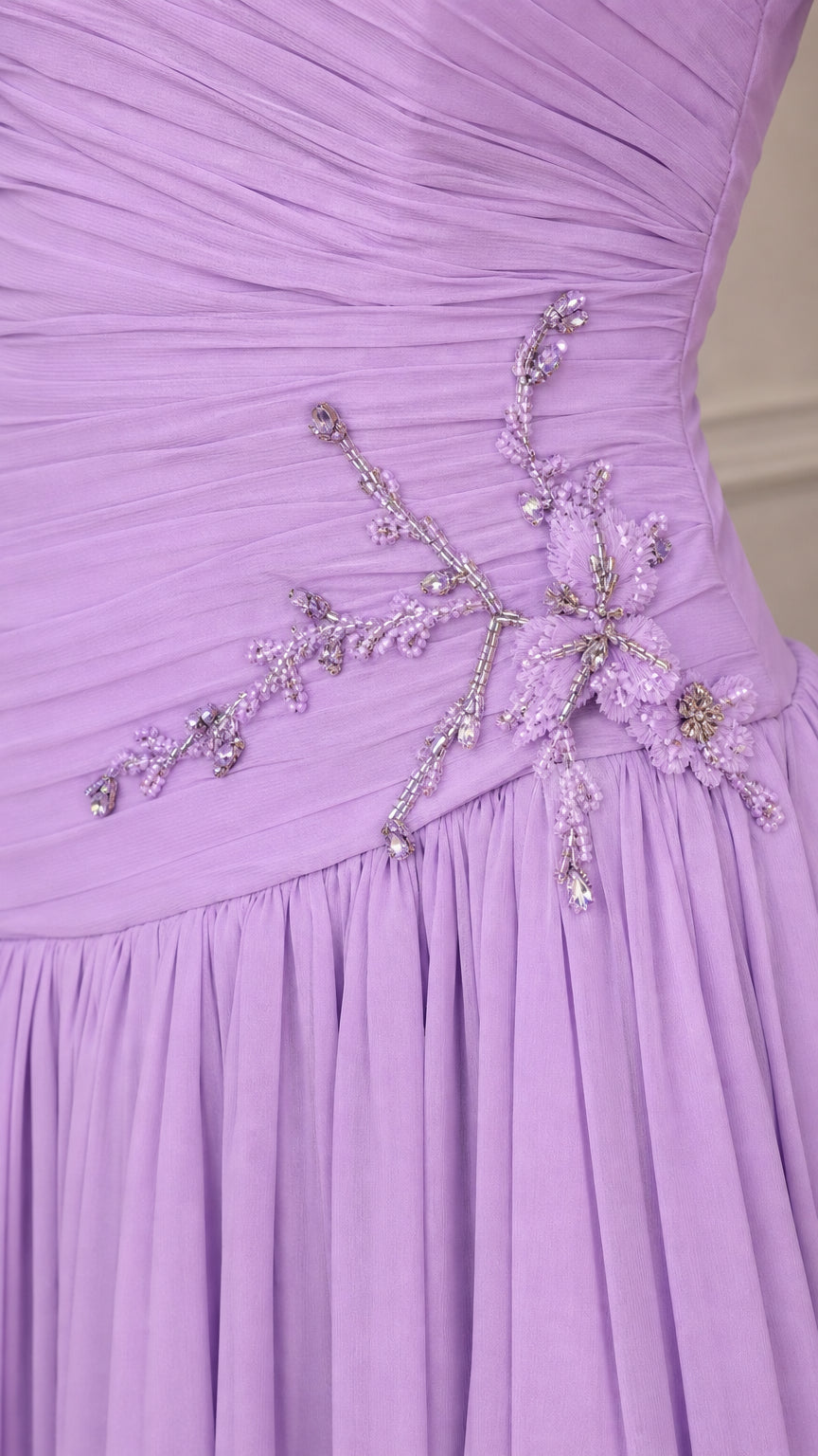 Close-up detail of beaded floral embellishment on ruched lavender bodice