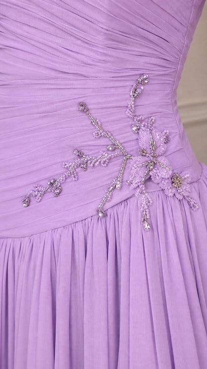 Close-up detail of beaded floral embellishment on ruched lavender bodice