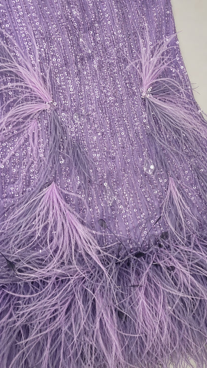 Close-up detail of sequins and feather trim on lavender dress
