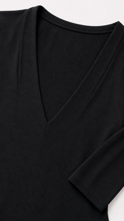 Close-up detail of the deep v-neckline and fabric texture