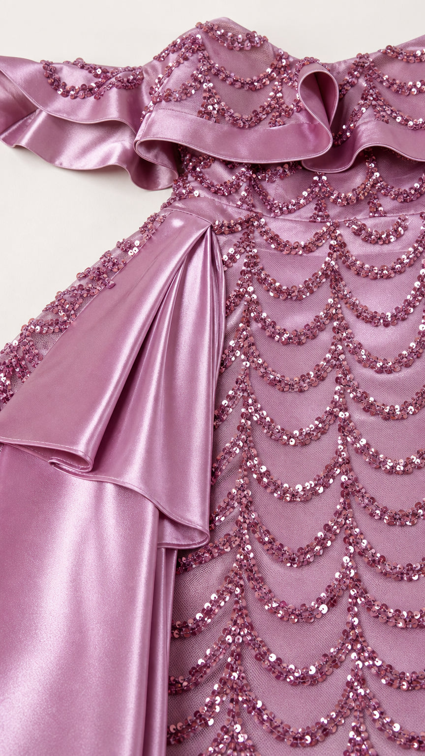 Close-up detail of ruffled neckline and sequin embroidery