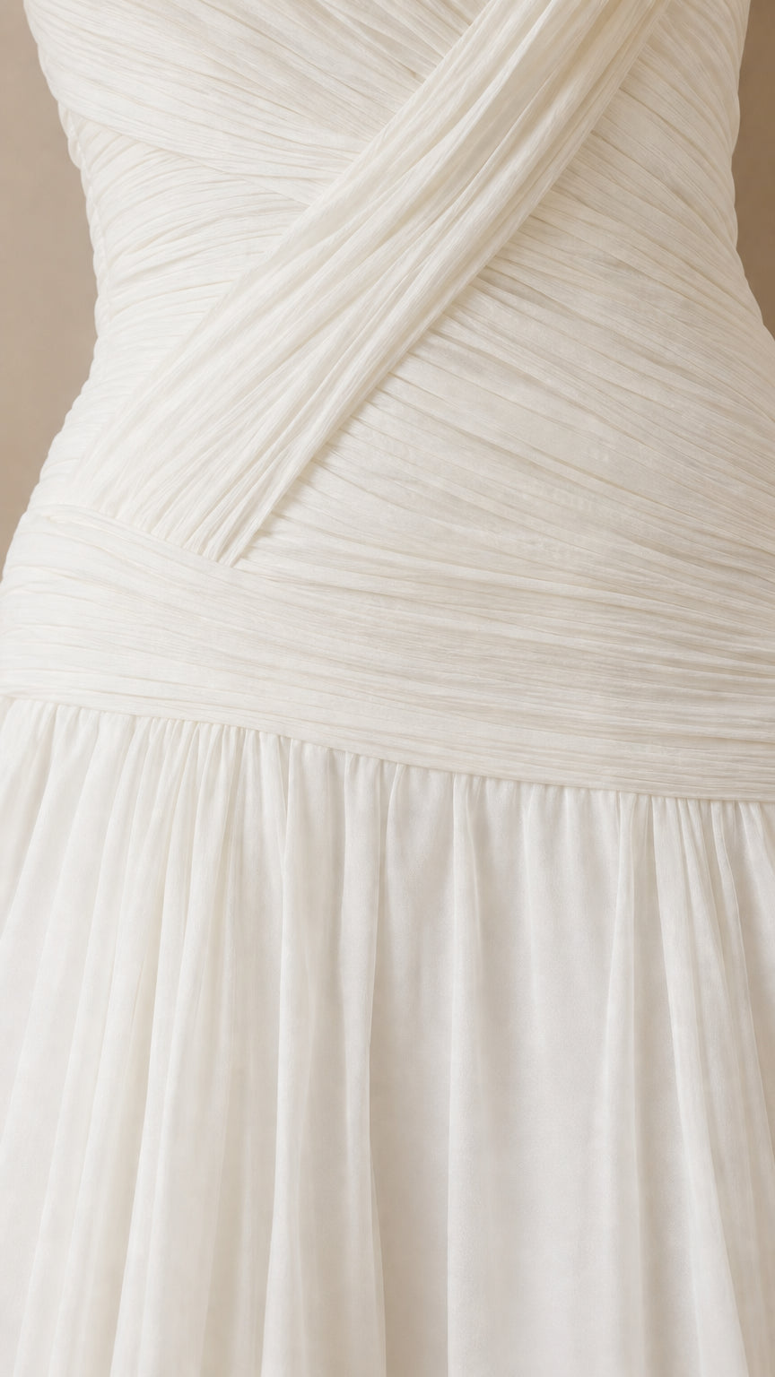 Close-up detail of white criss-cross pleated bodice and drop-waist seam