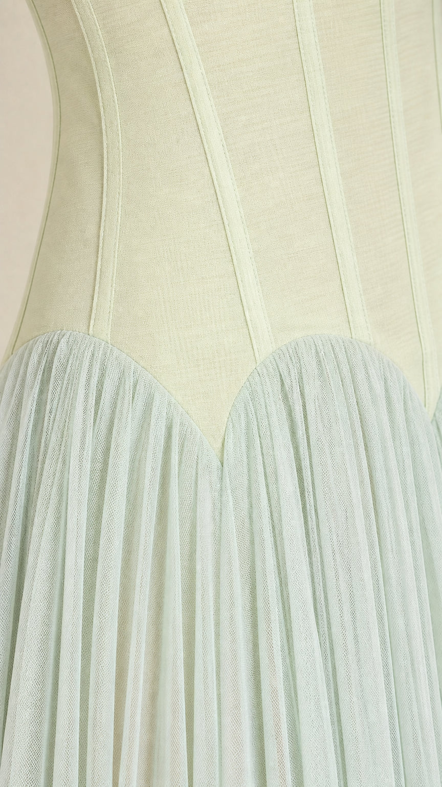Close-up of structured bodice and gathered tulle skirt on sage green dress