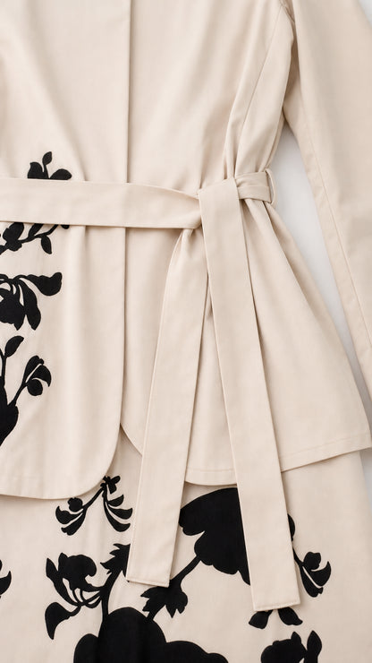 Close-up detail of belt and embroidery on beige maxi dress