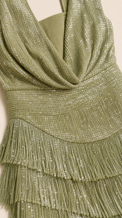 Close-up detail of sequined fabric, cowl neckline, and tiered fringe tassels