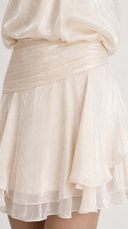 Close-up detail of draped waistband and ruffled hem