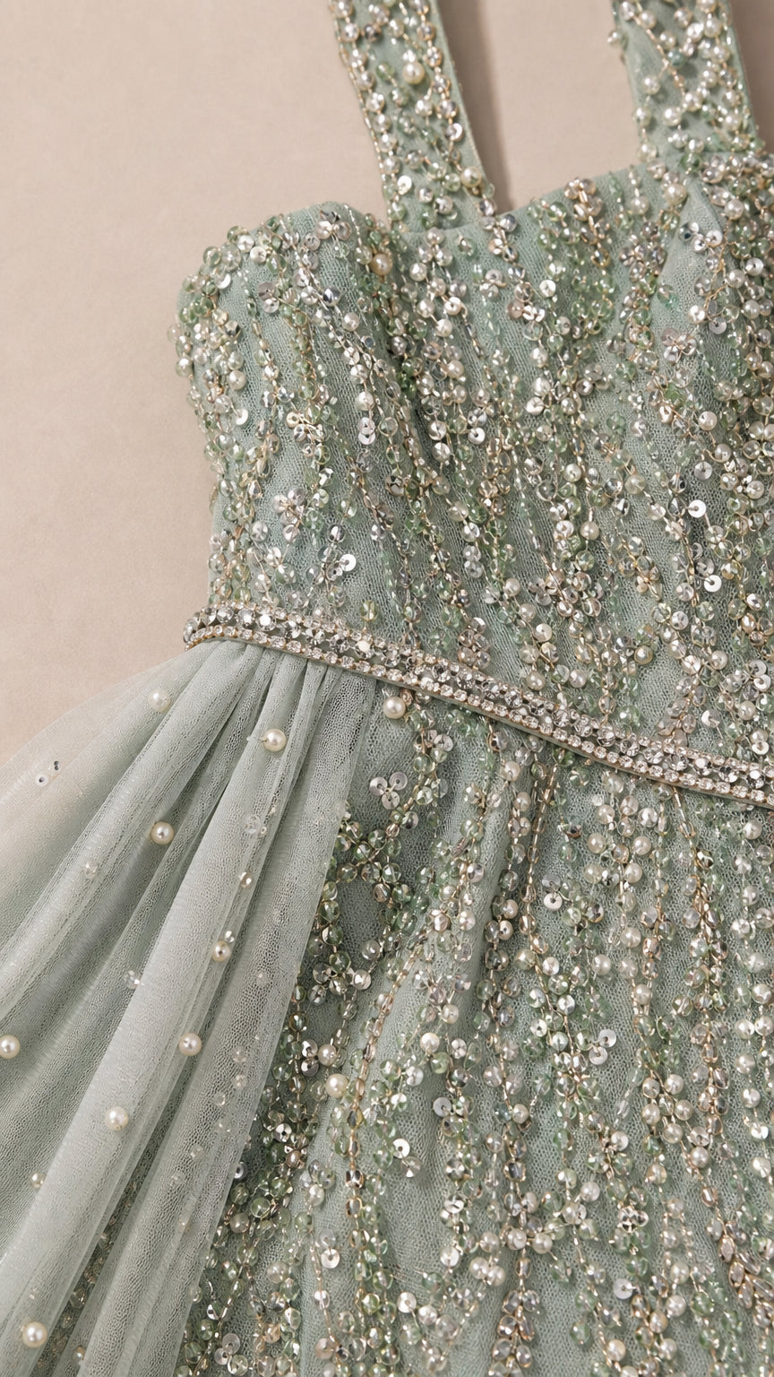 Close-up of beaded bodice, jeweled waist, and pearl-accented mesh details