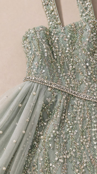 Close-up of beaded bodice, jeweled waist, and pearl-accented mesh details