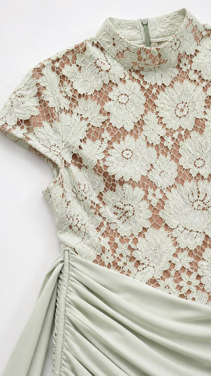 Close-up detail of sage green floral lace bodice and ruched skirt