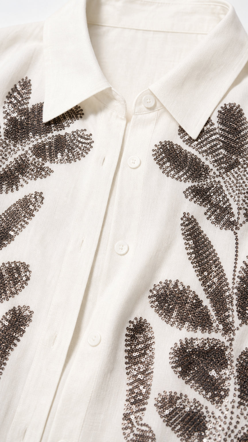 Close-up detail of shirt collar and beaded leaf embroidery