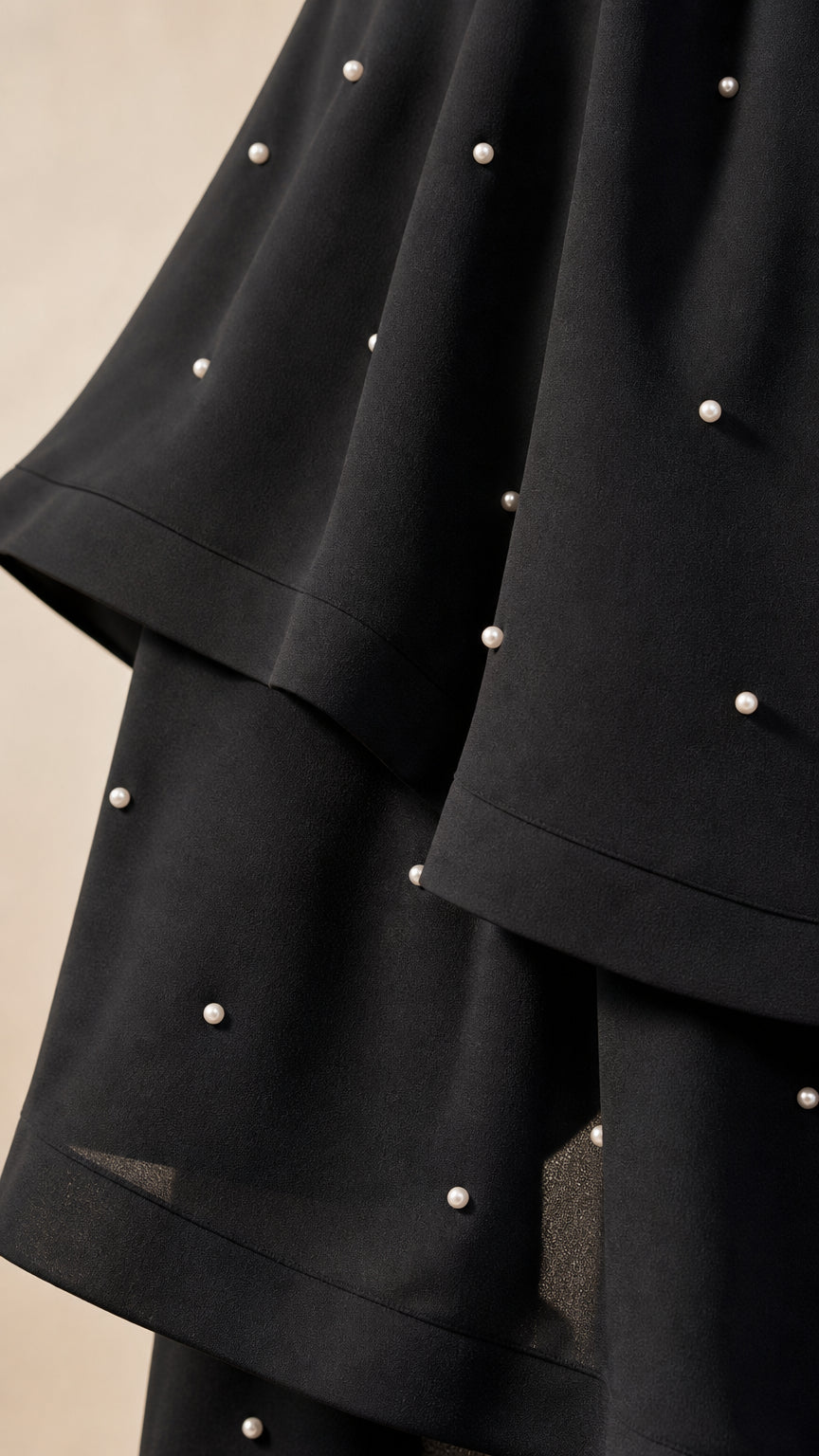 Close-up of pearl embellishments and tiered ruffles