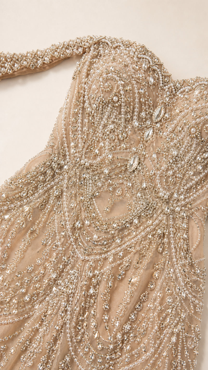 Close-up detail of intricate beading and crystal embellishments on the neckline