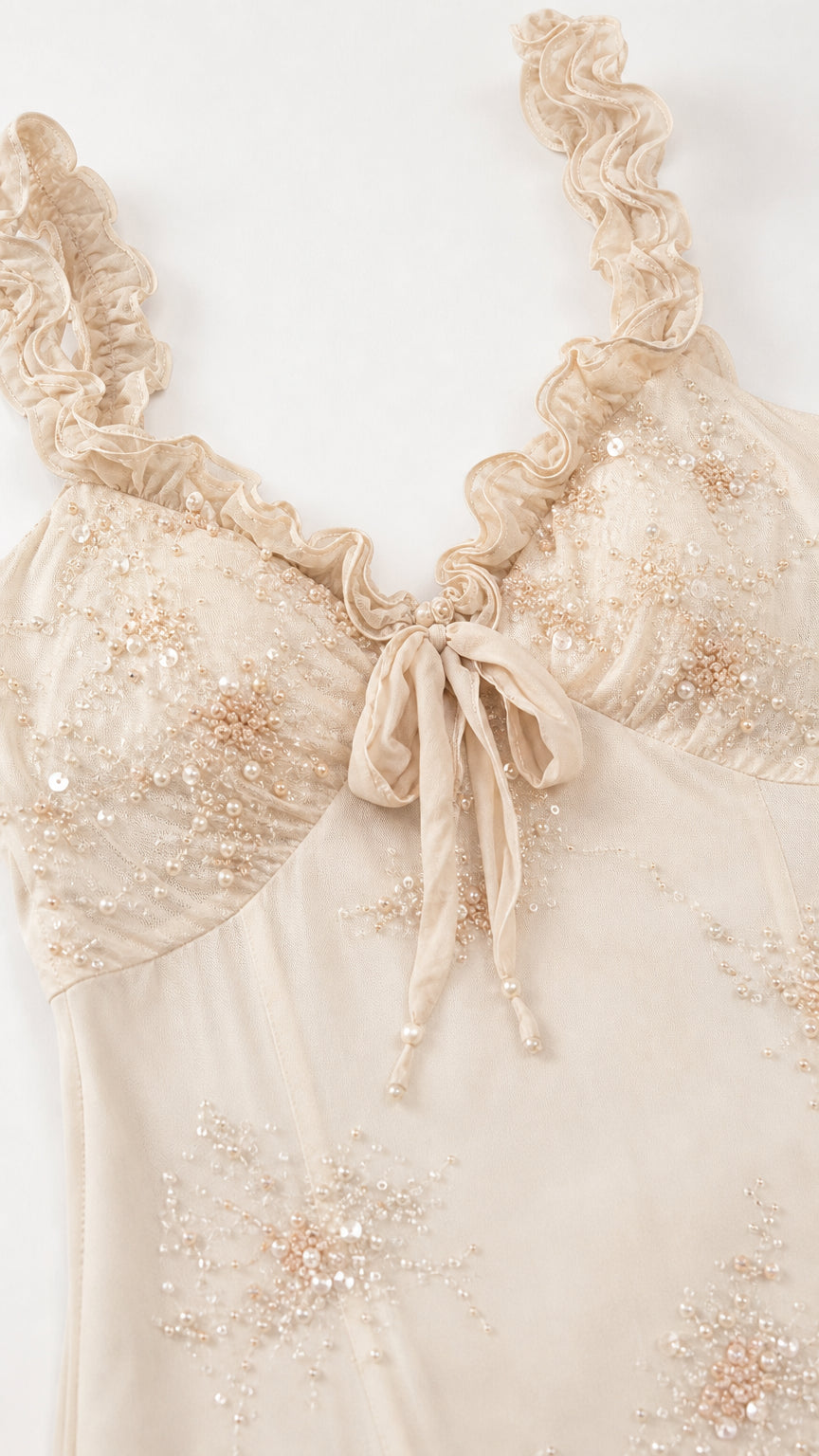 Close-up detail of beaded bodice and ruffled straps