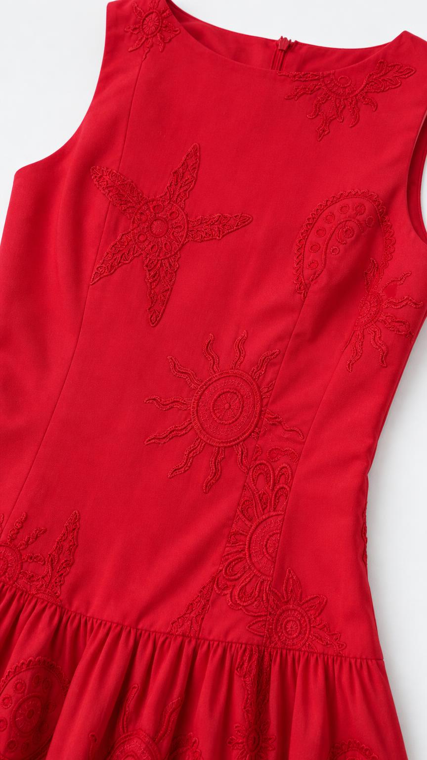 Close-up of red fabric with tonal sun and starfish embroidery details