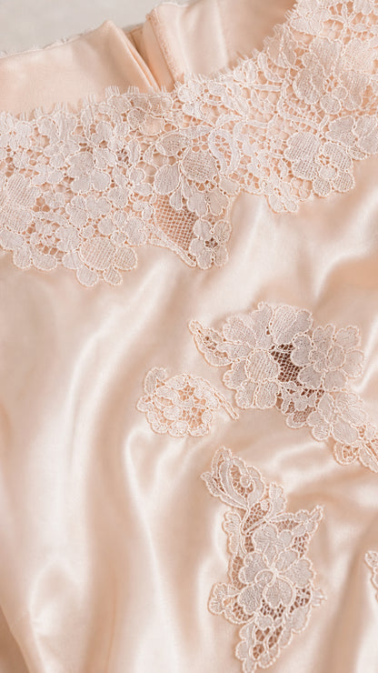 Close-up detail of lace appliqués on satin fabric