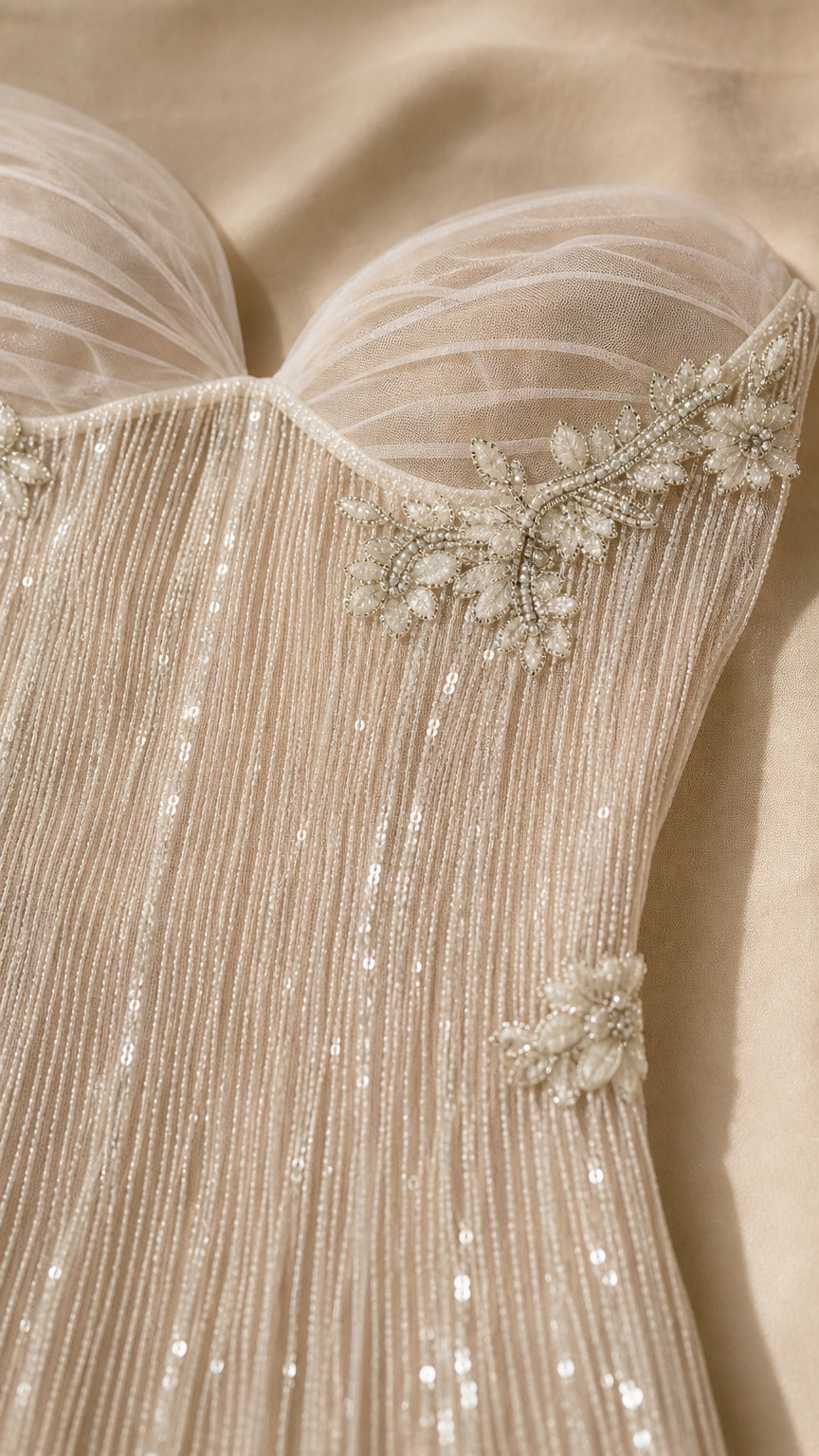 Close-up detail of sweetheart neckline, pleated tulle, and delicate floral beadwork