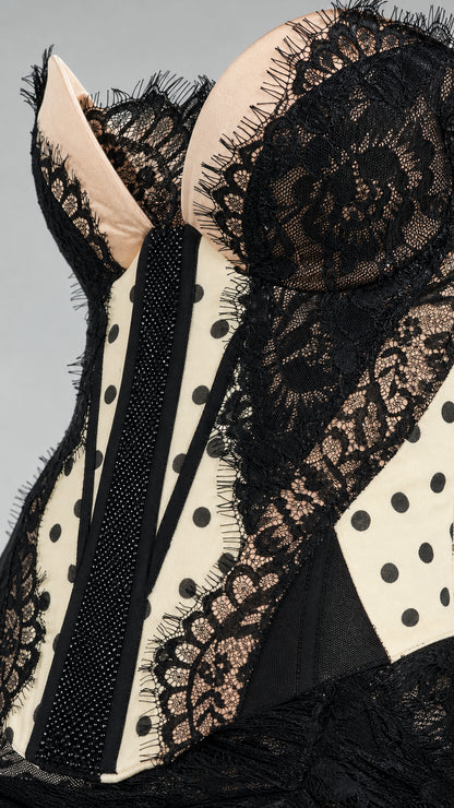 Close-up detail of polka dot corset bodice and lace trim