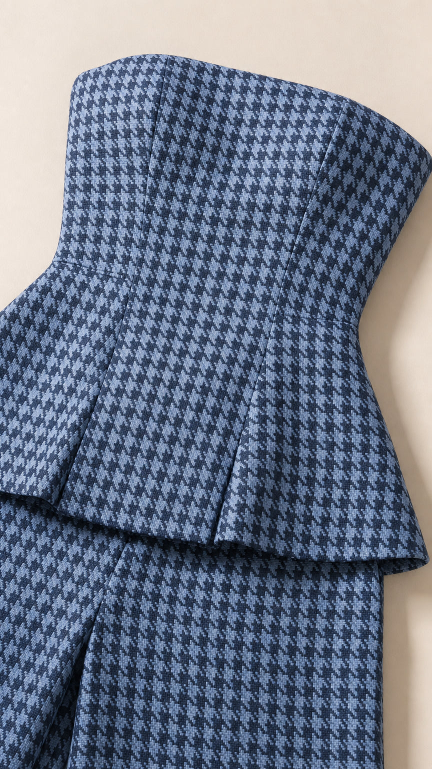 Close-up detail of blue hounds-tooth peplum top and trousers texture