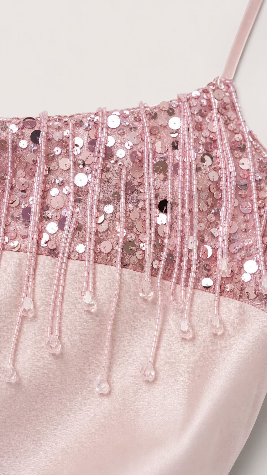 Close-up detail of sequin and beaded fringe on pink camisole