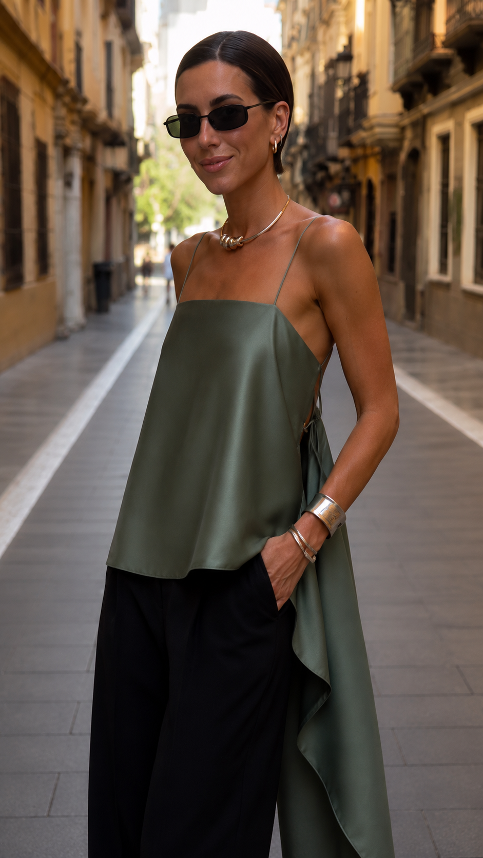 Close-up front view of sage green satin-look spaghetti strap top