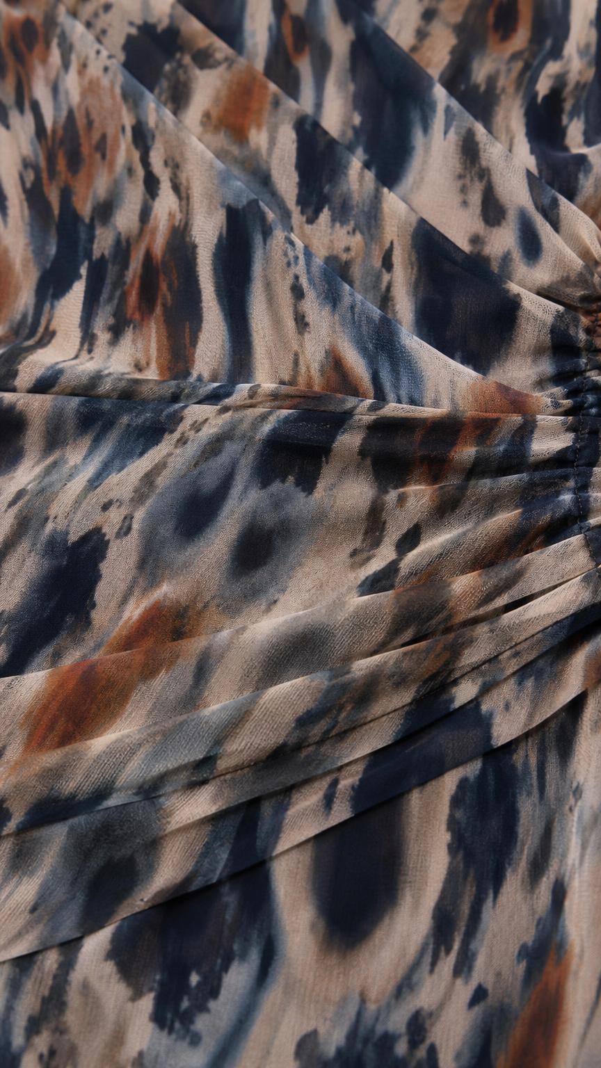 Close-up of textured abstract print fabric with pleats