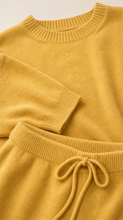 Close-up of the mustard knit texture, ribbed neckline, sleeve edge, and drawstring waist