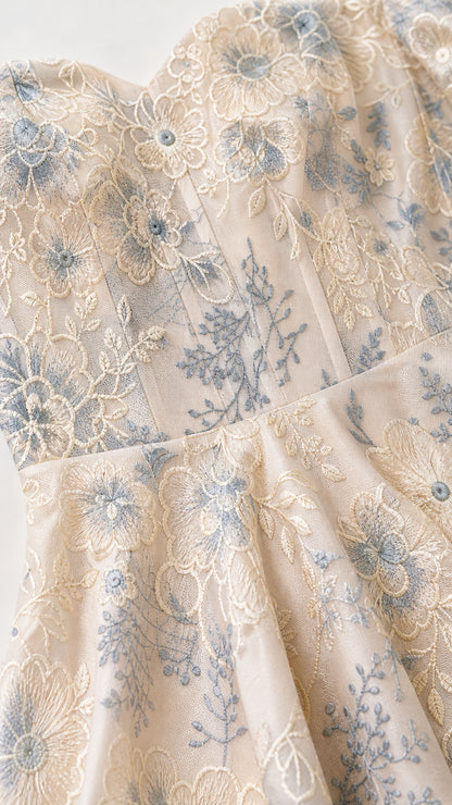 Close-up detail of floral embroidery and sweetheart neckline