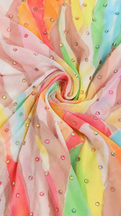 Close-up detail of colorful stretch mesh fabric with sparkling round rhinestones