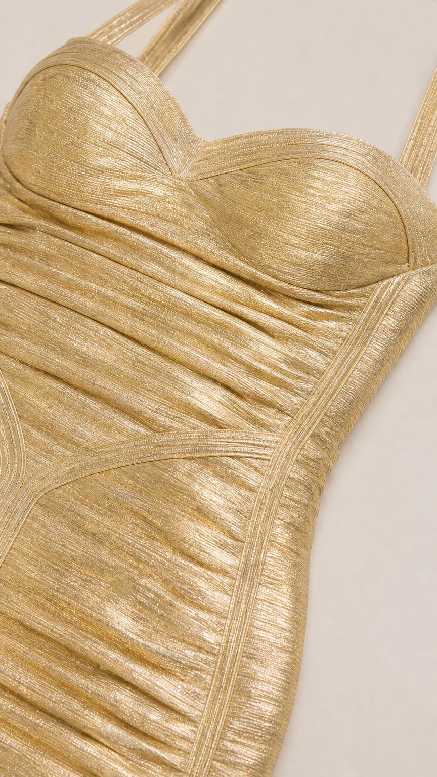 Close-up detail of metallic gold shimmering bandage fabric and sweetheart bustier