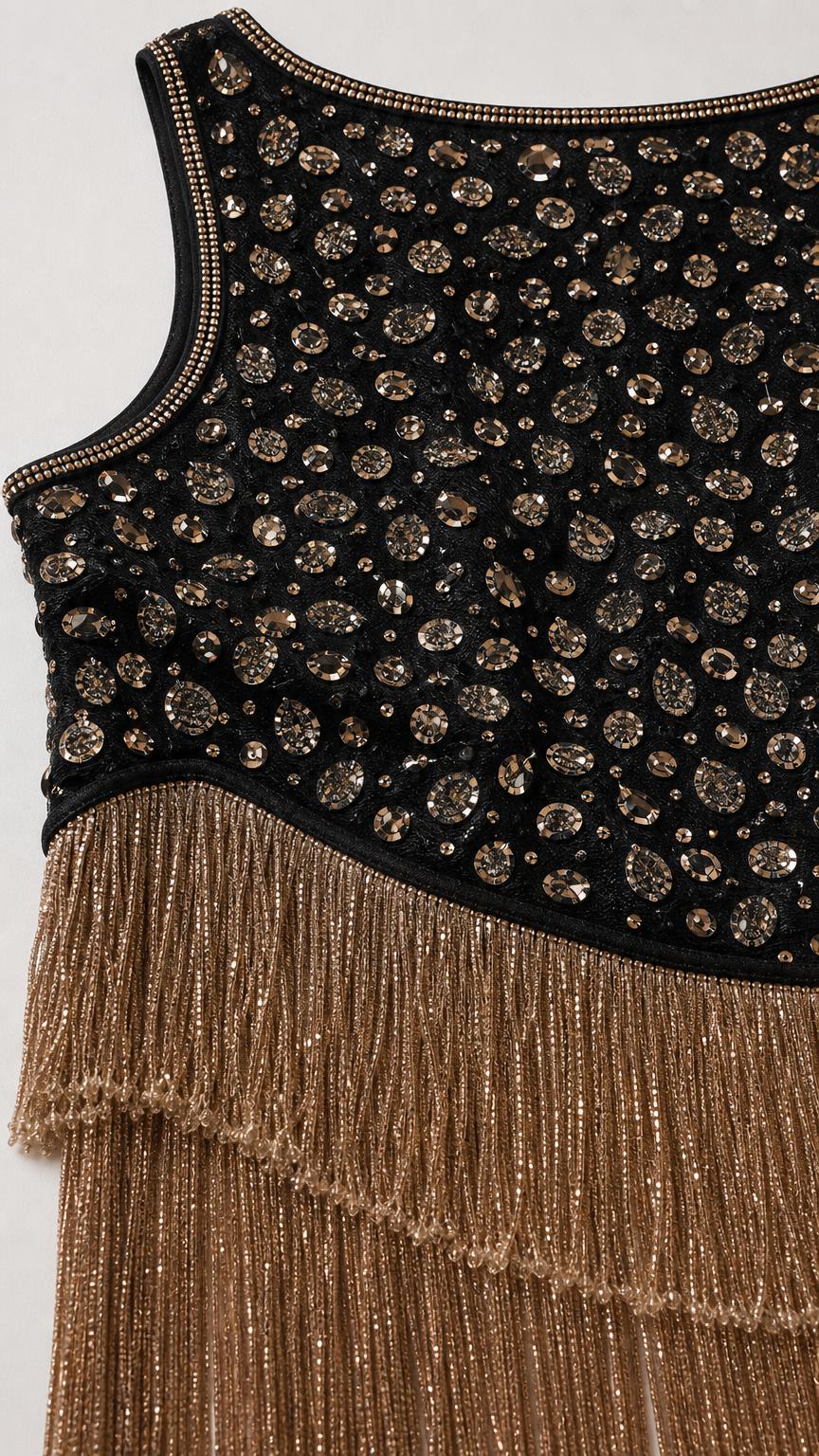 Close-up detail of upper bodice beadwork and tiered gold fringe hem