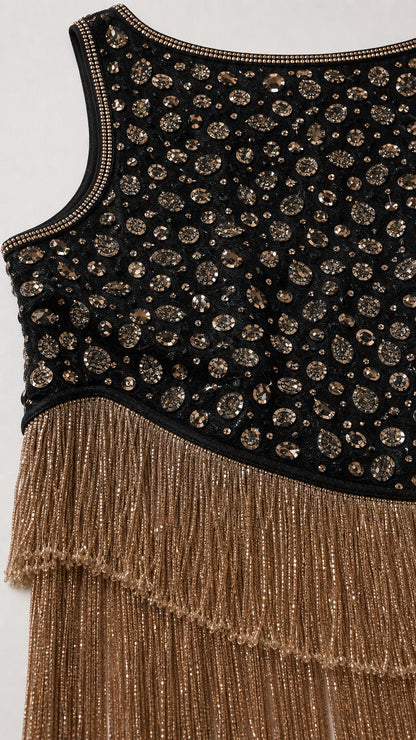 Close-up detail of upper bodice beadwork and tiered gold fringe hem