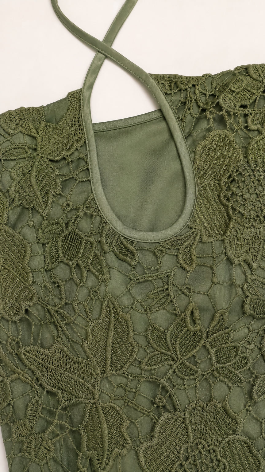 Close up of olive green floral lace and halter strap detail