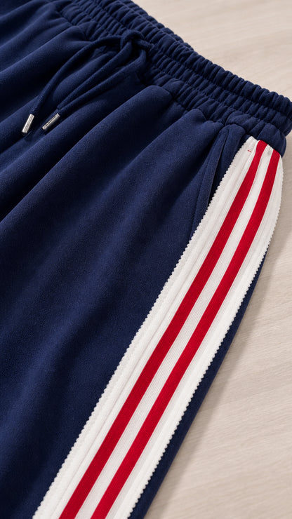 Close-up detail of Navy Blue sweatpants showing elastic waistband and striped side trim