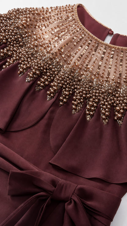Close-up detail of beaded neckline and capelet overlay