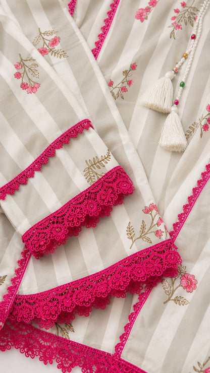 Close-up detail of lace trim and floral print on white kurti sleeves
