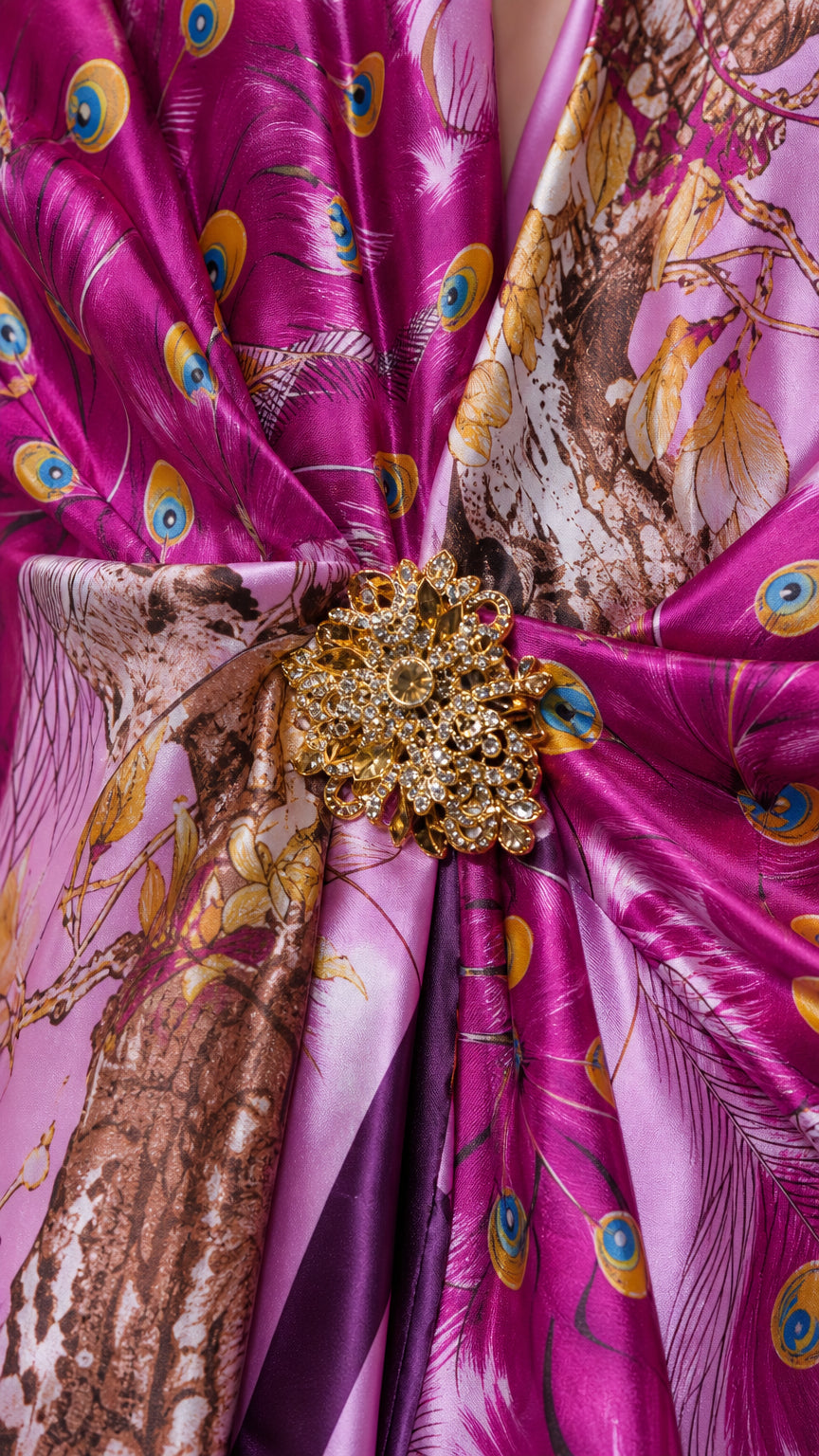 Close-up of the smooth satin-like peacock, floral, and ornate print fabric with waist accent