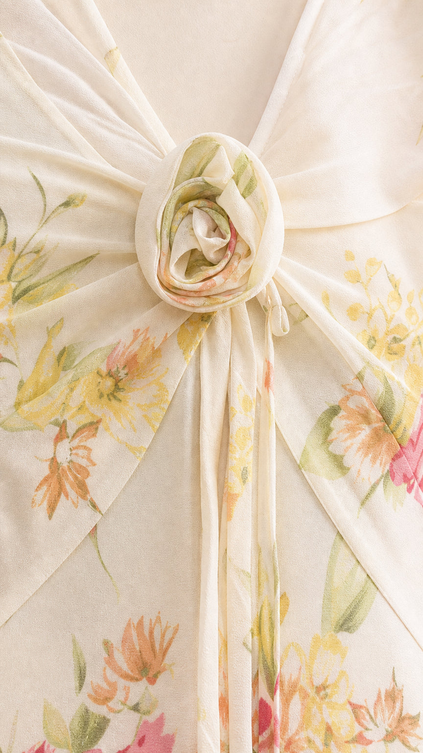 Close-up of gathered bust with floral rosette detail on cream dress